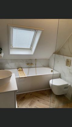 a bathroom with a skylight, toilet and bathtub in the middle of it