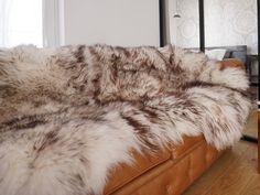 a fur covered couch in a living room