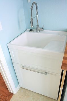 a white kitchen sink sitting under a faucet