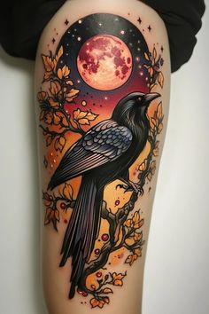 a black bird sitting on top of a tree branch with the moon in the background