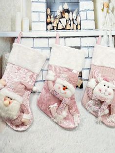 three christmas stockings with teddy bears hanging from them in front of a fire place and fireplace