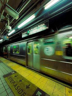 a subway train is moving through the station