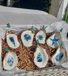 a basket filled with ceramic seashells on top of a table