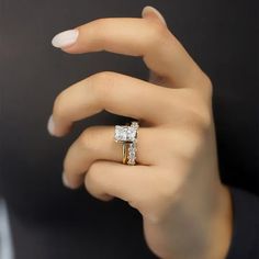 a woman's hand with a diamond ring on it