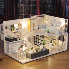 a doll house is shown with furniture and lights on the floor in front of it