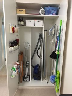 the closet is filled with cleaning supplies and other household items, including a vacuum cleaner