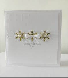 a white christmas card with bows and snowflakes