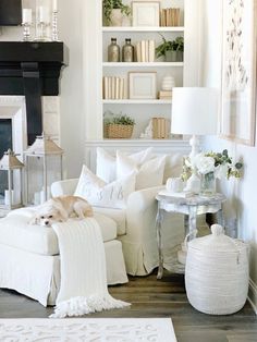 a living room filled with furniture and a fire place next to a white fireplace mantel