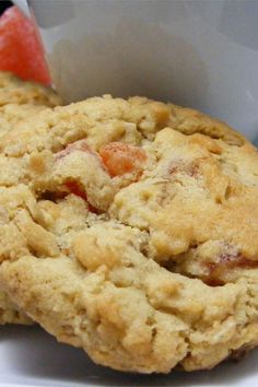 two cookies are sitting on a plate with watermelon slices in the back ground