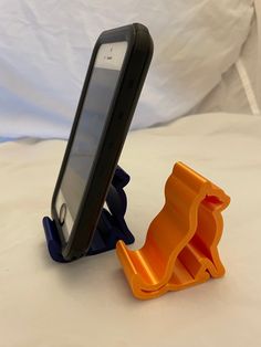 an orange and black cell phone holder on a white surface