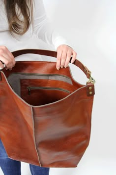 Cognac brown leather hobo This brown large tote bag is made from high quality italian leather. Spacious interior provides room for all the daily essentials and more. There is an inside zippered pocket. This bag is perfect as your everyday bag, which can fit an IPAD, laptop, A4 files, books, magazines, cosmetic bag as well as many accessories. This bag has top zipper closure for safety. Height: 18,5 inch (47 cm) Width: 18,1 inch (46 cm) Length of handle: 19,3 inch (49 cm) Bottom width: 13,4x 5,5 Brown Leather Lined Shoulder Bag For Errands, Brown Leather-lined Shoulder Bag For Errands, Leather-lined Bucket Hobo Bag, Brown Leather Hobo Bag For Everyday Use, Brown Soft Leather Hobo Bag For On-the-go, Brown Leather Lining Bucket Shoulder Bag, Cognac Leather-lined Tote Weekender Bag, Everyday Cognac Hobo Tote Bag, Leather Hobo Bag With Zipper Pocket For Shopping