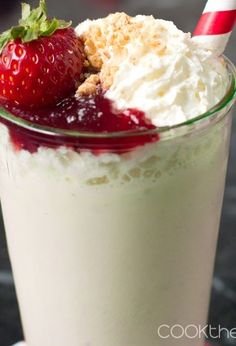 a strawberry milkshake with whipped cream and strawberries