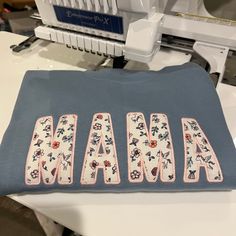 the name mamma is made out of quilts on a table next to a sewing machine