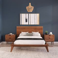 a bedroom with blue walls and wooden furniture