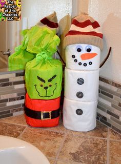 two snowmen made out of toilet paper sitting next to each other on a bathroom counter