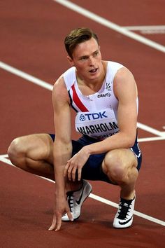 a man kneeling down on top of a track