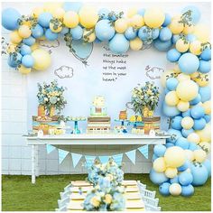 a blue and yellow dessert table with balloons