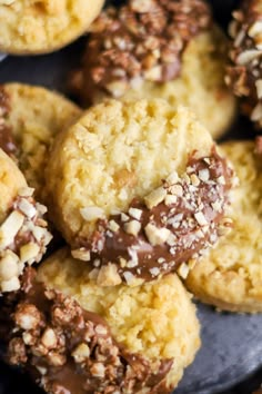 several cookies with chocolate and nuts on a plate