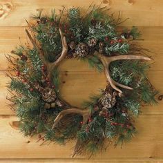 a christmas wreath with antlers and pine cones