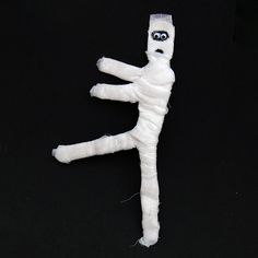 a white doll is posed in the shape of a person