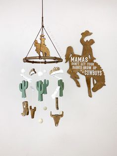 a wind chime hanging from the ceiling next to a wall with wooden cutouts