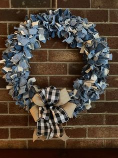 a blue and white wreath hanging on a brick wall