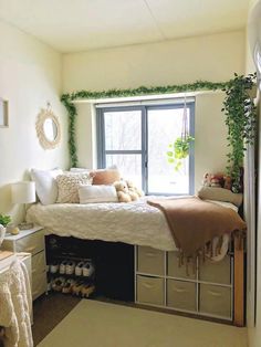 a bedroom with white walls and lots of greenery on the window sill above the bed