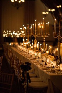 a long table with many candles and chairs