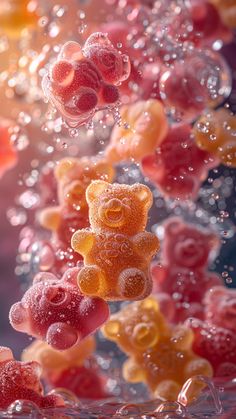 gummy bears are floating in the air with water droplets on them and bubbles around them