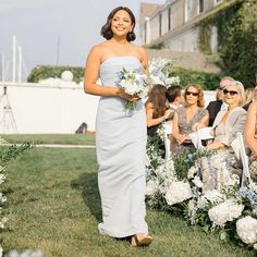 a woman walking down the aisle at a wedding