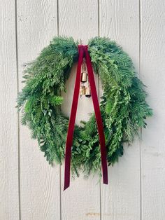 a christmas wreath hanging on the side of a building