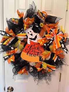 a halloween wreath is hanging on the front door