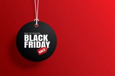 a black friday sale tag hanging on a red wall