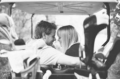 a man and woman sitting in a golf cart