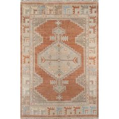 an orange and blue rug with geometric designs on the front, in various colors and shapes