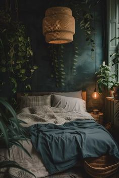 a bedroom with green walls and plants in the corner, along with an unmade bed