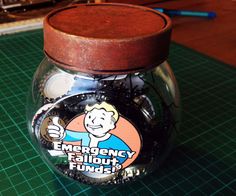 a glass jar filled with money sitting on top of a table