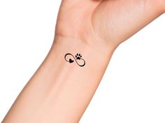 a person's arm with a small tattoo on the left side of their wrist