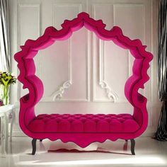 a pink bench sitting in front of a mirror