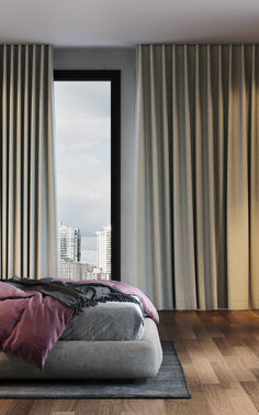 a bed sitting in front of a window next to a wooden floor