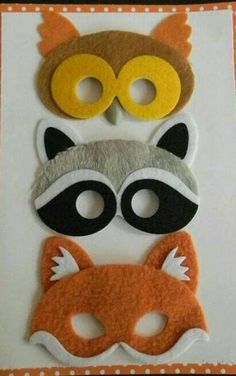 three masks with different animal faces on top of each other, one has a fox and the other is a raccoon