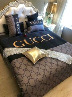 a gucci bed with gold and black pillows