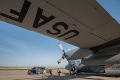 an airplane is parked on the tarmac with people around it