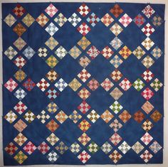 a blue quilt with different colored squares on it