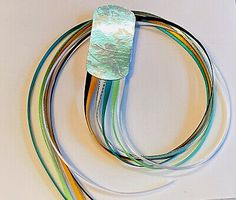 an assortment of colored wires on a white surface