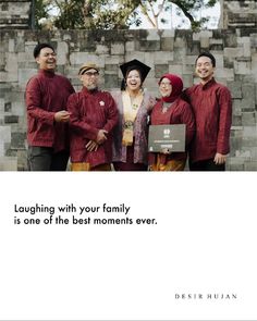 a group of people standing next to each other in front of a brick wall with the caption laughing with your family is one of the best moments ever