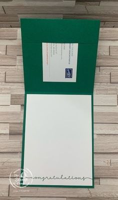 an open green folder with white paper on top