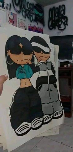 someone holding up a drawing of two people