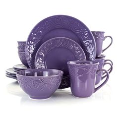 purple dishes and cups are stacked on top of each other