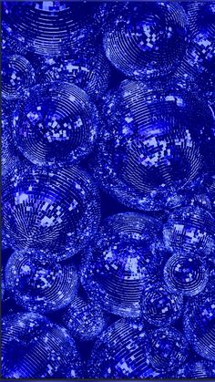 blue glass balls are stacked up together